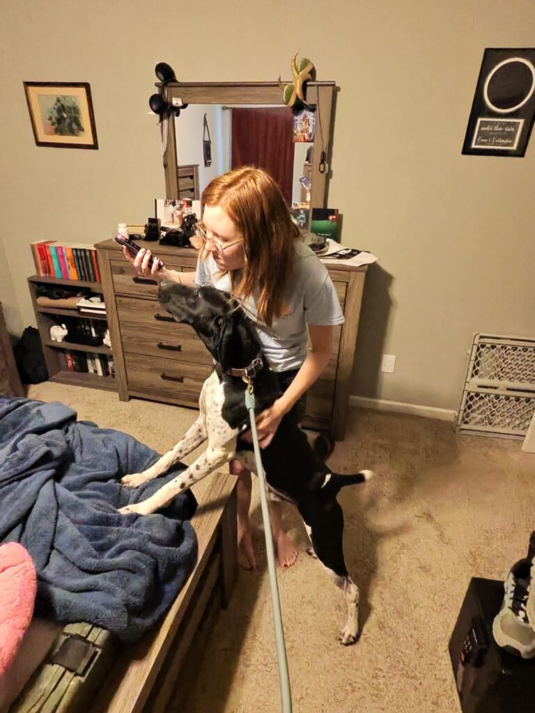 A women with a mold dog in a room in Washington.