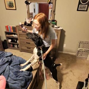 A women with a mold dog in a room in Washington.